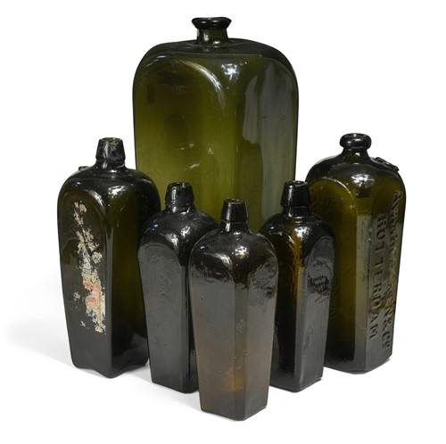 Lot 350 - A collection of six graduated dark glass rectangular bottles, Dutch 19th century