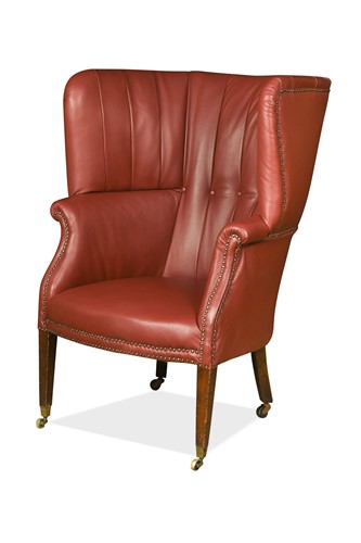 Lot 457 - A late George III barrel back leather armchair